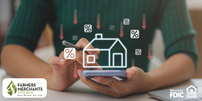 Person holding smartphone with illustration of home and percentage icons with down arrows