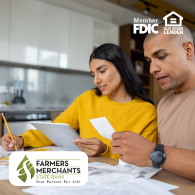 Young couple organizing their receipts and finances at the kitchen table