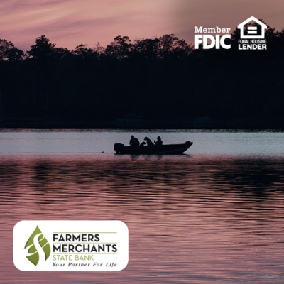 People on a small boat on a lake during sunset