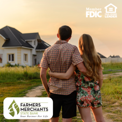 Man and woman standing together looking at a house in the distance